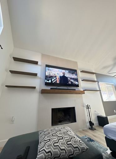 Finished large-format tile fireplace with floating shelves