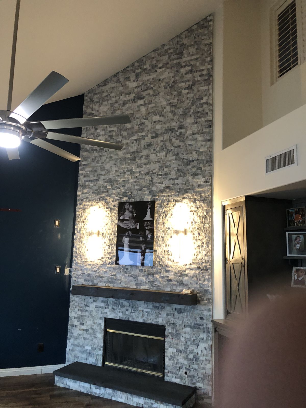 Finished floor-to-ceiling stacked stone fireplace
