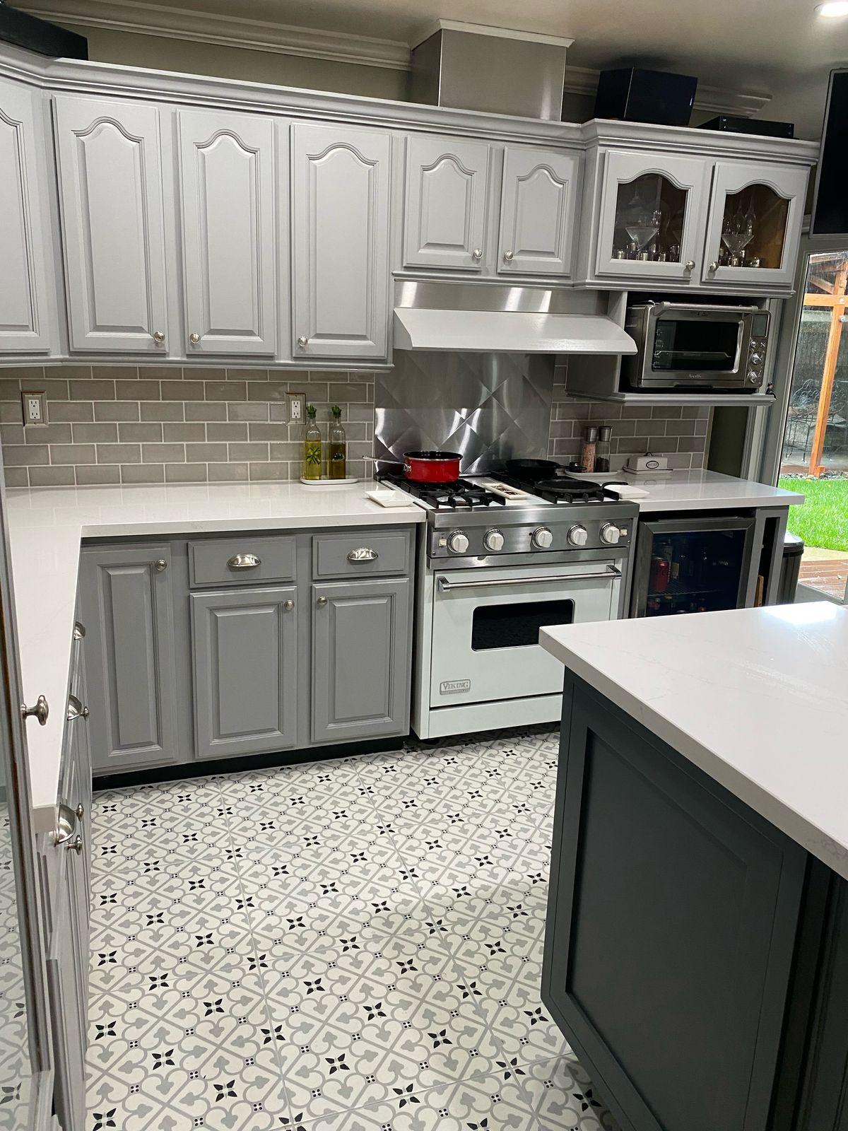 Kitchen after, with a patterned porcelain floor and gray subway backsplash