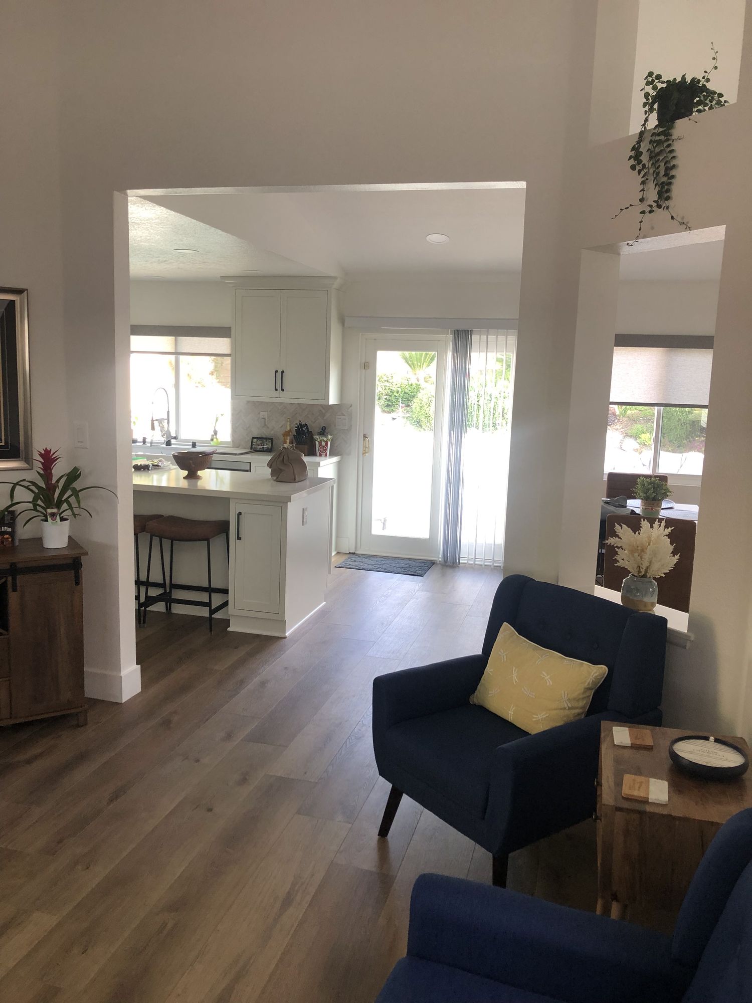 After: wall opened up into a bright kitchen with new flooring